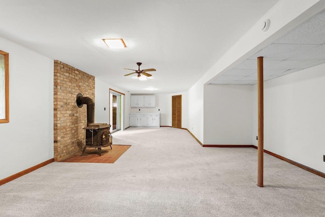 2806 Mckenna Blvd, Madison, WI 53719 - unfurnished living room featuring a wood stove, light carpet, and a ceiling fan