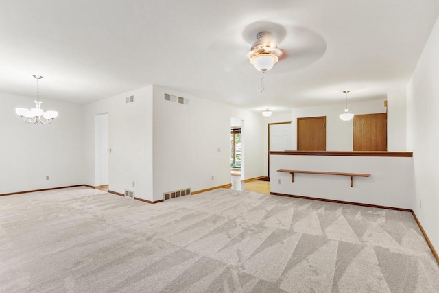 2806 Mckenna Blvd, Madison, WI 53719 - unfurnished living room with light carpet, ceiling fan, and a chandelier