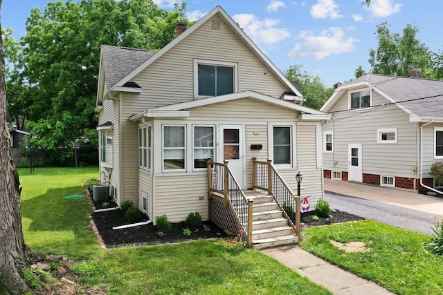 911 W Bent Ave, Oshkosh, WI 54901 - view of front of property with a front lawn, a chimney, and a shingled roof