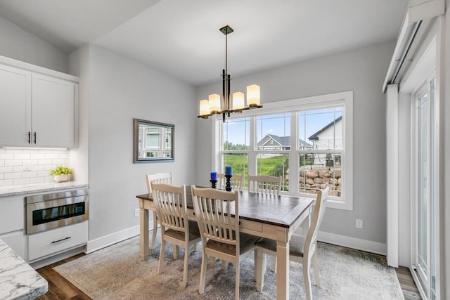 1152 Prairie View Dr, Waunakee, WI 53597 - dining space featuring dark wood-type flooring and a chandelier
