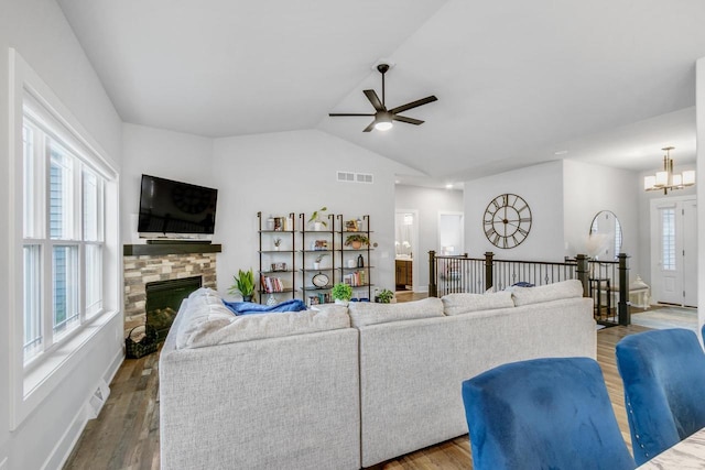 1152 Prairie View Dr, Waunakee, WI 53597 - living room featuring a ceiling fan, a fireplace, vaulted ceiling, a chandelier, and wood finished floors