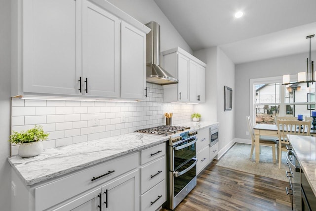 1152 Prairie View Dr, Waunakee, WI 53597 - kitchen with wall chimney exhaust hood, stainless steel appliances, dark wood-style floors, white cabinets, and recessed lighting