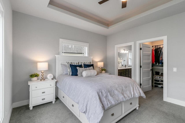 1152 Prairie View Dr, Waunakee, WI 53597 - bedroom with light colored carpet, a spacious closet, a raised ceiling, ensuite bath, and a closet