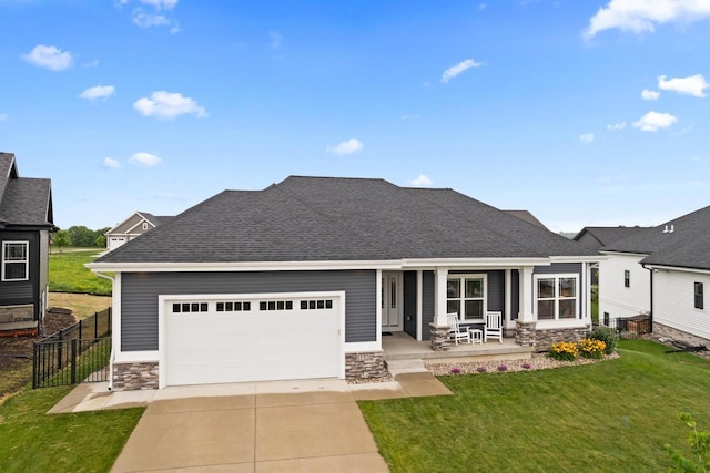 1152 Prairie View Dr, Waunakee, WI 53597 - view of front of house featuring stone siding, covered porch, a garage, driveway, and a shingled roof