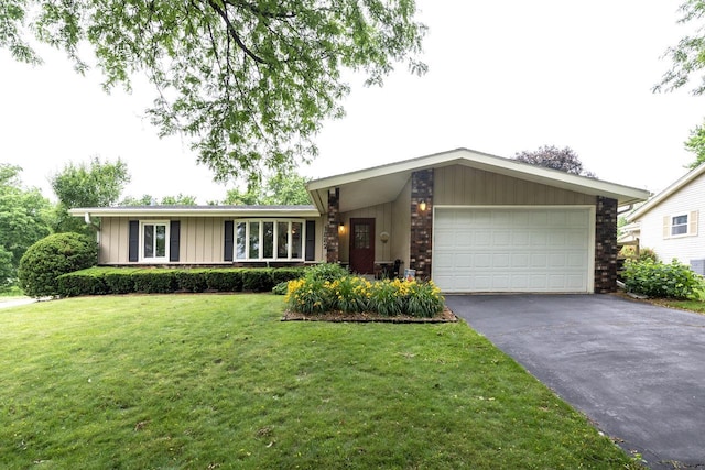 1882 Davis Ln, Waukesha, WI 53189 - view of front of house with board and batten siding, a garage, driveway, and a front lawn
