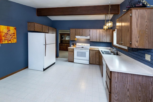 1882 Davis Ln, Waukesha, WI 53189 - kitchen with white appliances, under cabinet range hood, light countertops, backsplash, and decorative light fixtures