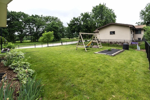1882 Davis Ln, Waukesha, WI 53189 - fenced backyard with a playground and view of scattered trees