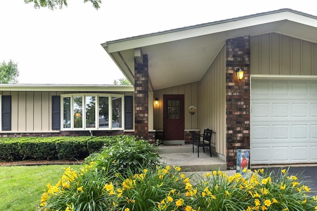 1882 Davis Ln, Waukesha, WI 53189 - doorway to property with board and batten siding, brick siding, and an attached garage
