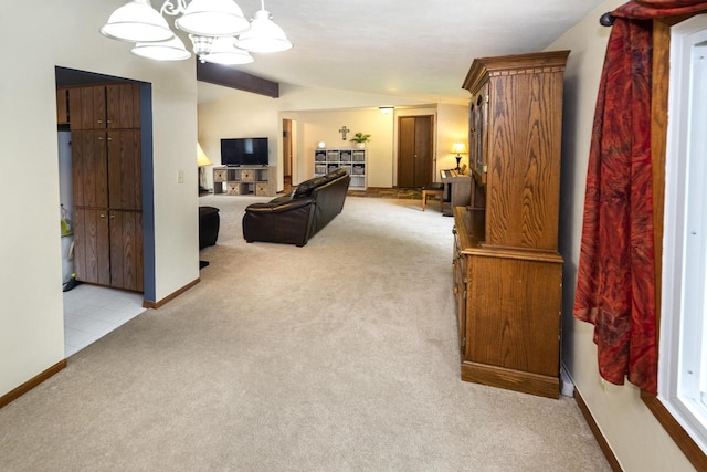 1882 Davis Ln, Waukesha, WI 53189 - living room featuring light colored carpet, lofted ceiling, and a chandelier