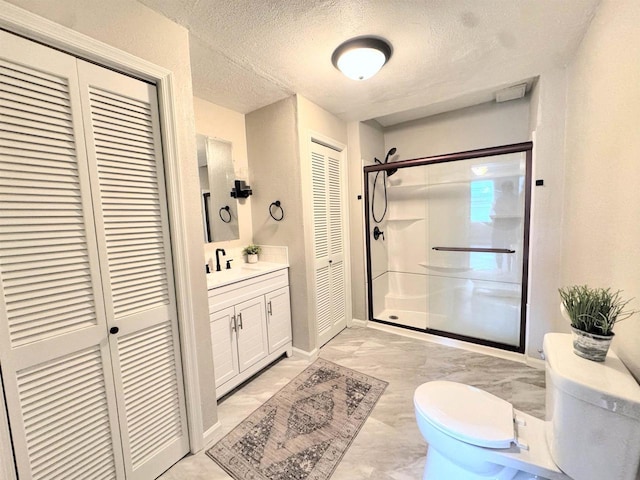 229 Bacon Ave, Oshkosh, WI 54901 - bathroom with a closet, marble finish floors, a stall shower, vanity, and a textured ceiling