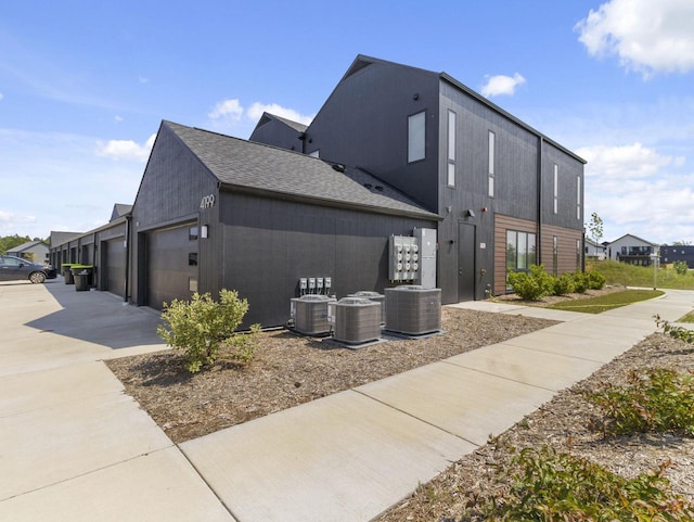 4199 E Hemlock Dr Unit 108, Oak Creek, WI 53154 - view of property exterior with a garage, driveway, and roof with shingles