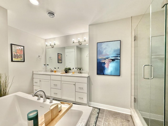 2324 Boulder Ln, Beloit, WI 53511 - bathroom featuring double vanity, a stall shower, and a tub