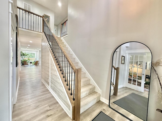 2324 Boulder Ln, Beloit, WI 53511 - staircase with wood finished floors, a towering ceiling, and arched walkways
