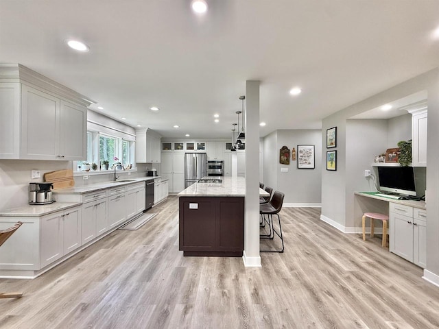 2324 Boulder Ln, Beloit, WI 53511 - kitchen featuring stainless steel appliances, a breakfast bar area, recessed lighting, white cabinetry, and light wood finished floors