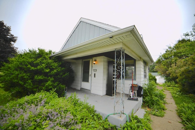 6818 W Morgan Ave, Milwaukee, WI 53220 - view of front facade featuring board and batten siding and covered porch