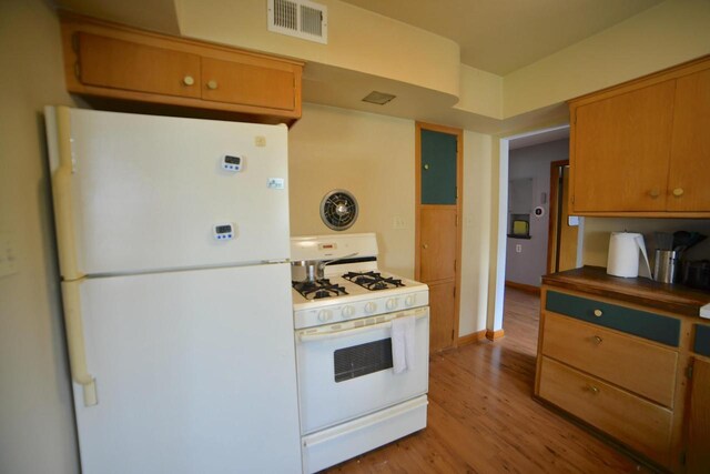 6818 W Morgan Ave, Milwaukee, WI 53220 - kitchen with white appliances, light wood-style flooring, and brown cabinetry