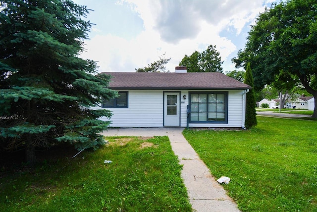 5625 N 57th St, Milwaukee, WI 53218 - view of front of home with a front yard and a chimney