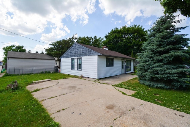 5625 N 57th St, Milwaukee, WI 53218 - back of house featuring a patio, a yard, and a chimney