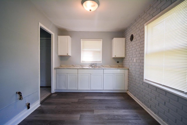 5625 N 57th St, Milwaukee, WI 53218 - kitchen featuring white cabinetry, light countertops, dark wood-style floors, and brick wall