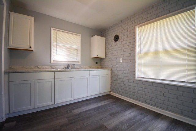 5625 N 57th St, Milwaukee, WI 53218 - kitchen with brick wall, white cabinets, and dark wood-style flooring