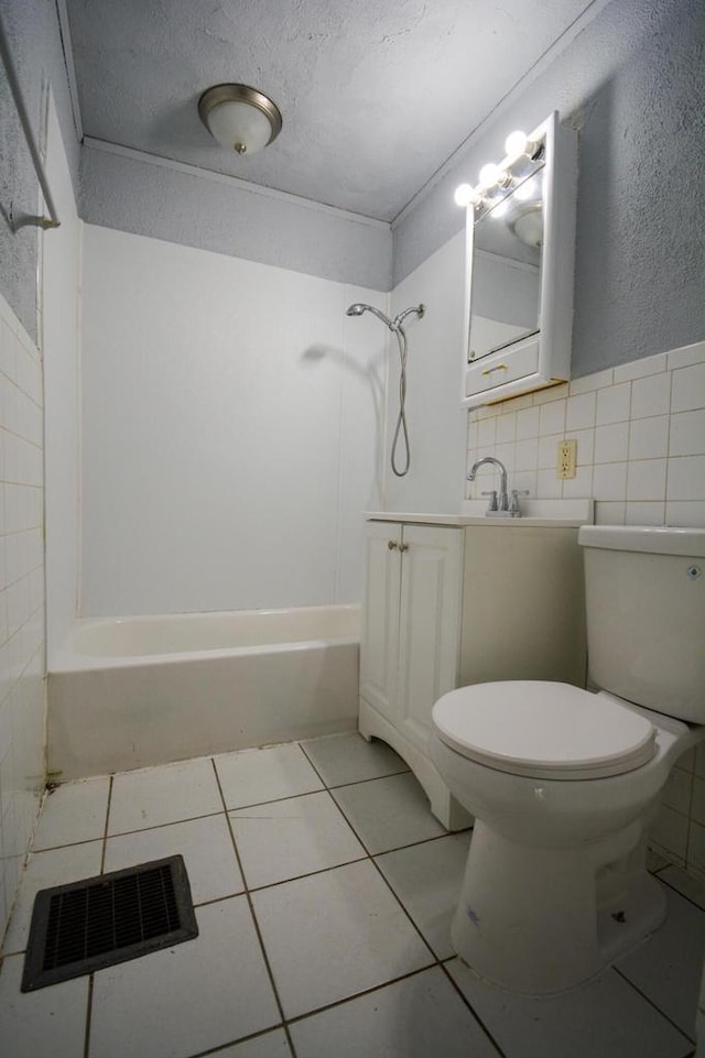 5625 N 57th St, Milwaukee, WI 53218 - full bathroom with tile patterned floors, shower / washtub combination, vanity, a textured ceiling, and tile walls