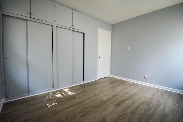 5625 N 57th St, Milwaukee, WI 53218 - unfurnished bedroom with wood finished floors and two closets