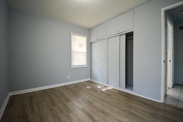 5625 N 57th St, Milwaukee, WI 53218 - unfurnished bedroom featuring wood finished floors and multiple closets