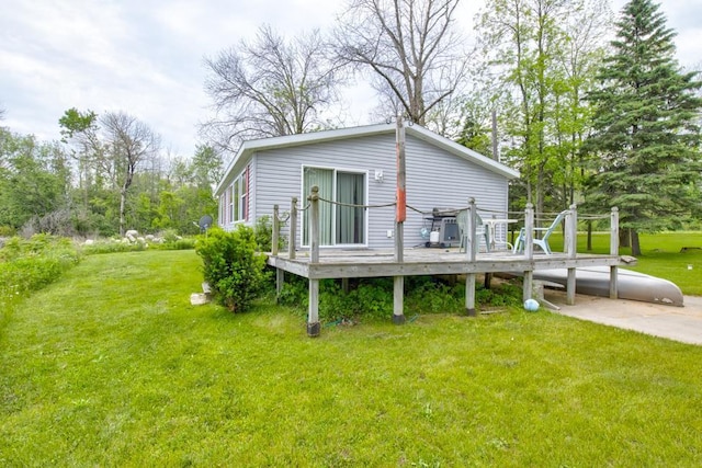 N3688 M-35, Menominee, MI 49858 - back of property featuring a wooden deck and a lawn