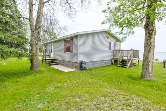 N3688 M-35, Menominee, MI 49858 - view of side of home featuring crawl space, a lawn, and a deck