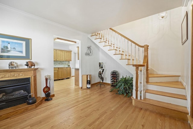 442 E Richardson Springs Rd, Edgerton, WI 53534 - stairway featuring wood finished floors, ornamental molding, and a glass covered fireplace