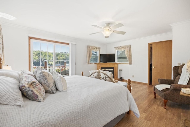 442 E Richardson Springs Rd, Edgerton, WI 53534 - bedroom with wood finished floors, ornamental molding, a glass covered fireplace, and ceiling fan