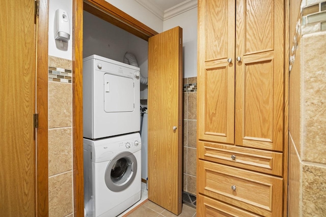442 E Richardson Springs Rd, Edgerton, WI 53534 - laundry room with stacked washer / drying machine, crown molding, light tile patterned flooring, and tile walls