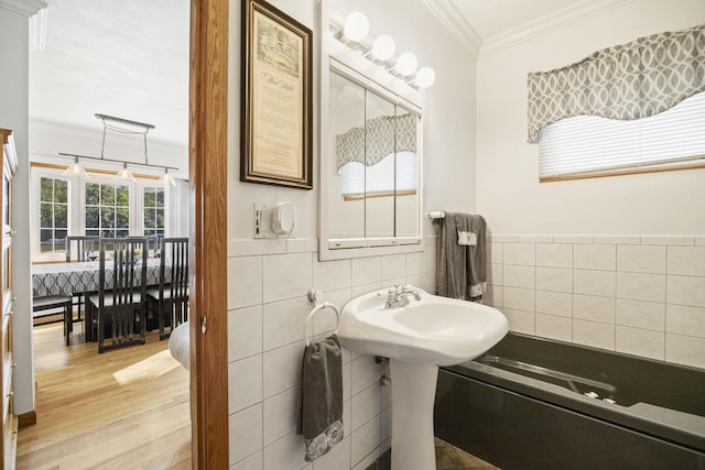 442 E Richardson Springs Rd, Edgerton, WI 53534 - bathroom featuring crown molding, wood finished floors, and tile walls
