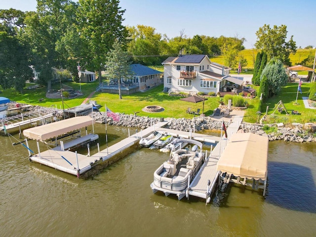 442 E Richardson Springs Rd, Edgerton, WI 53534 - dock area featuring boat lift, an outdoor fire pit, a water view, and a lawn
