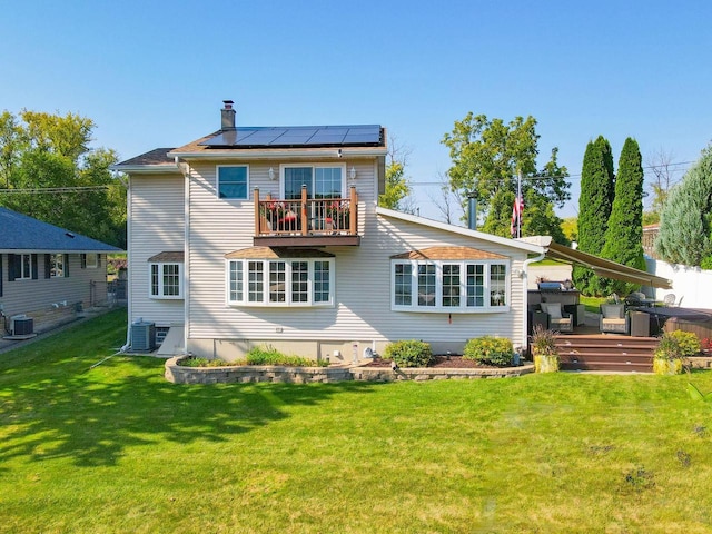 442 E Richardson Springs Rd, Edgerton, WI 53534 - rear view of property with roof mounted solar panels, a wooden deck, a lawn, a balcony, and a chimney