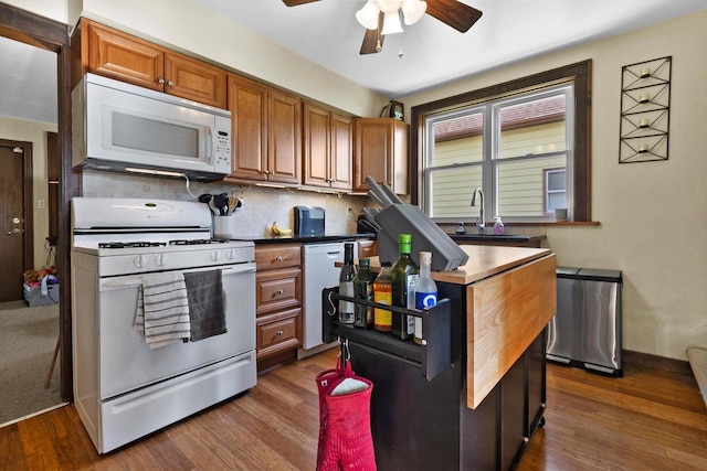 2147 S 71st St, West Allis, WI 53219 - kitchen with white appliances, ceiling fan, dark wood finished floors, brown cabinets, and backsplash