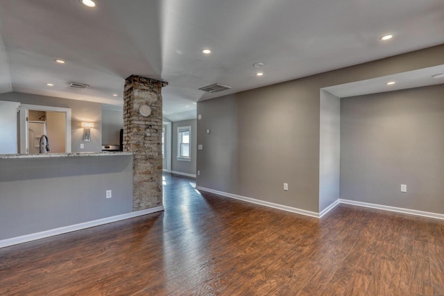 1626 N Warren Ave, Milwaukee, WI 53202 - unfurnished living room with ornate columns, wood finished floors, and recessed lighting