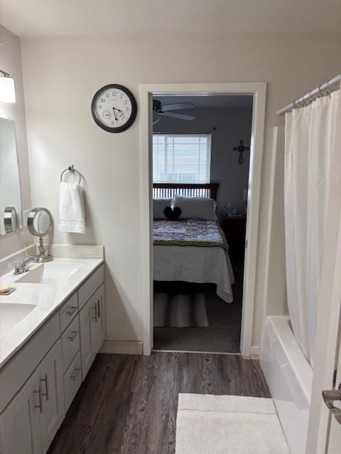 1965 N Windsor Ave, Cottage Grove, WI 53527 - ensuite bathroom featuring wood finished floors, double vanity, shower / bath combo, and ceiling fan
