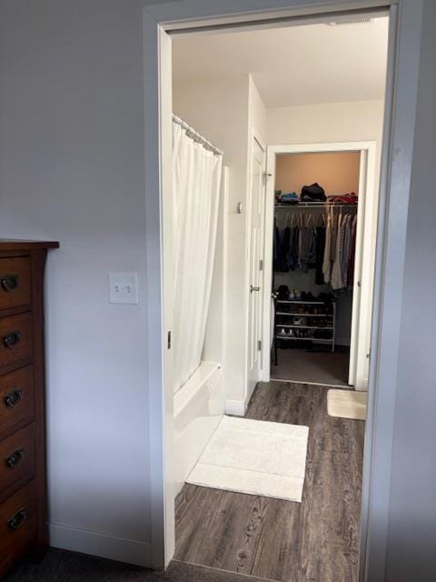 1965 N Windsor Ave, Cottage Grove, WI 53527 - bathroom with wood finished floors, shower / bathtub combination with curtain, and a walk in closet