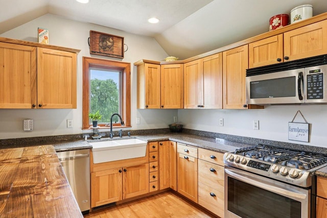 N64W20755 Mill Rd, Menomonee Falls, WI 53051 - kitchen featuring stainless steel appliances, lofted ceiling, light wood-style flooring, and recessed lighting