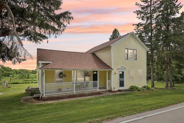 N64W20755 Mill Rd, Menomonee Falls, WI 53051 - traditional-style home featuring a porch, roof with shingles, and a yard