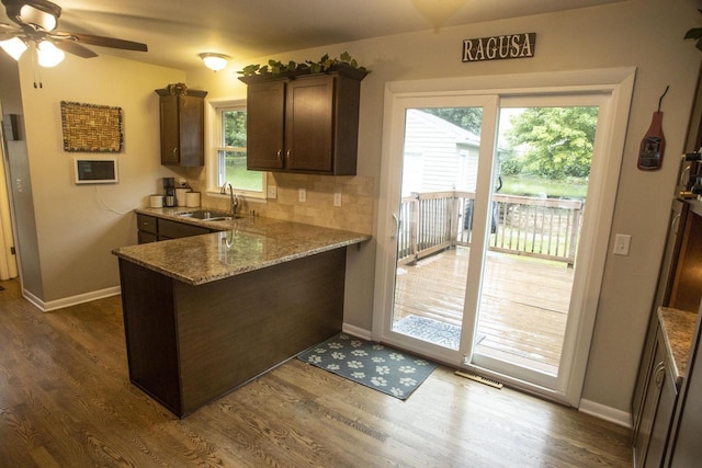 2563 S 91st St, West Allis, WI 53227 - kitchen featuring a peninsula, dark brown cabinets, healthy amount of natural light, and a ceiling fan