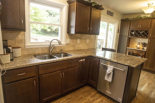 2563 S 91st St, West Allis, WI 53227 - kitchen with stainless steel dishwasher, decorative backsplash, dark wood-style flooring, and a peninsula