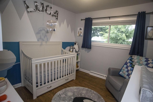 2563 S 91st St, West Allis, WI 53227 - bedroom with a baseboard radiator, a crib, and wood finished floors