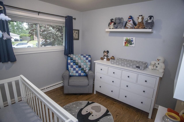 2563 S 91st St, West Allis, WI 53227 - bedroom featuring a baseboard heating unit, a crib, and wood finished floors