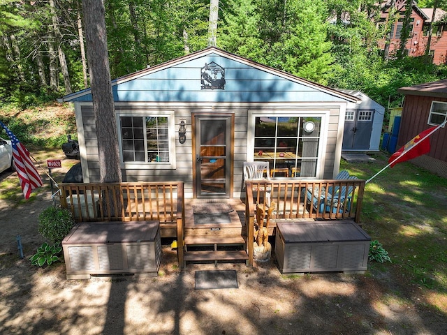 W6020 Northern Lights Cir Unit 7, Tomahawk, WI 54487 - view of front of home featuring a wooden deck and an outbuilding