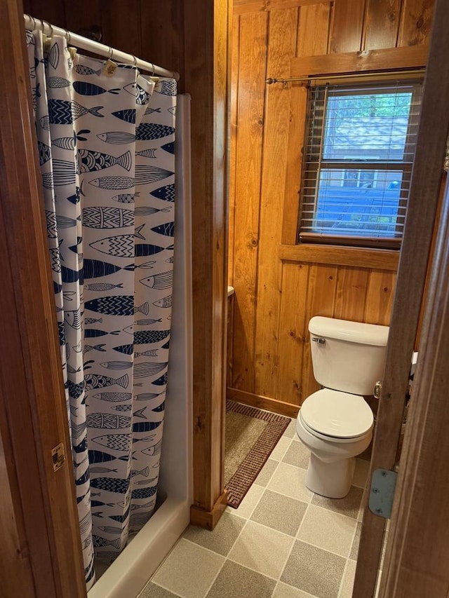 W6020 Northern Lights Cir Unit 7, Tomahawk, WI 54487 - full bath featuring wooden walls, tile patterned floors, and curtained shower
