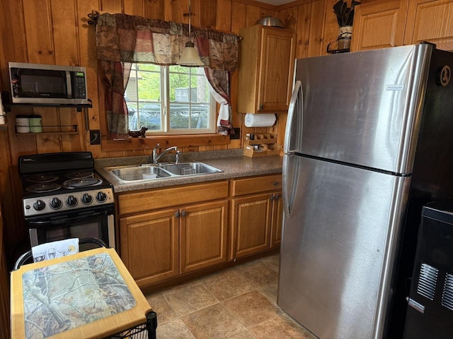 W6020 Northern Lights Cir Unit 7, Tomahawk, WI 54487 - kitchen featuring stainless steel appliances, wooden walls, brown cabinets, and dark countertops