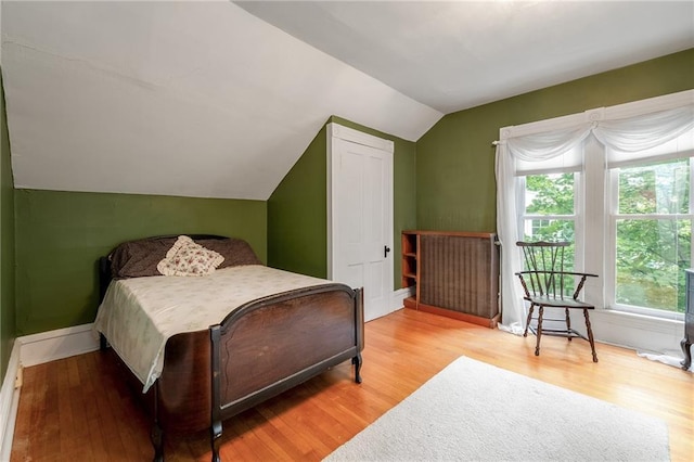 246 Coleman St, Chippewa Falls, WI 54729 - bedroom with lofted ceiling, multiple windows, and wood finished floors