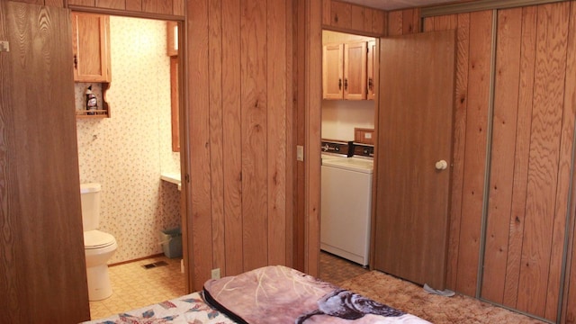 2301 County Road Z Unit 17, Friendship, WI 53934 - bedroom featuring washer / dryer, tile patterned floors, and ensuite bathroom